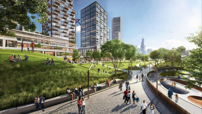 A city with tall, modern glass-fronted buildings and a lively pedestrian green space in the foreground